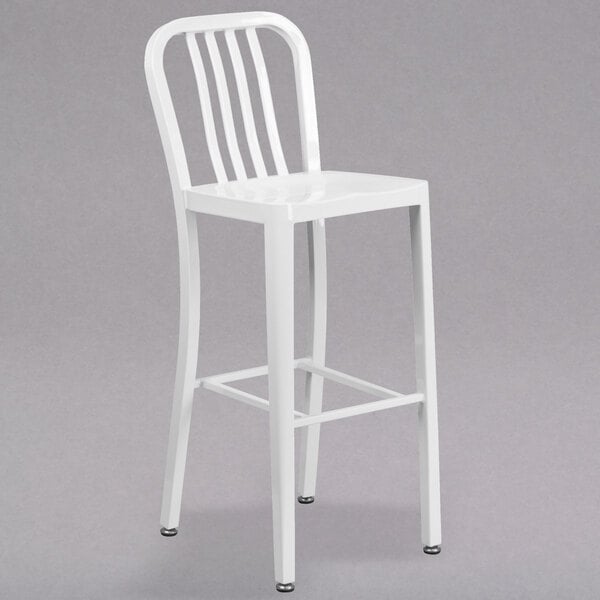 A Flash Furniture white metal bar stool with a vertical slat back.