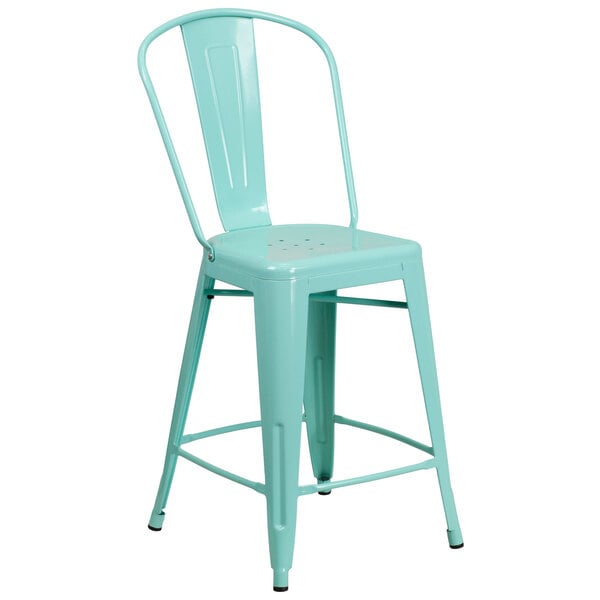 A mint green galvanized steel counter height stool with a slat back and drain hole.