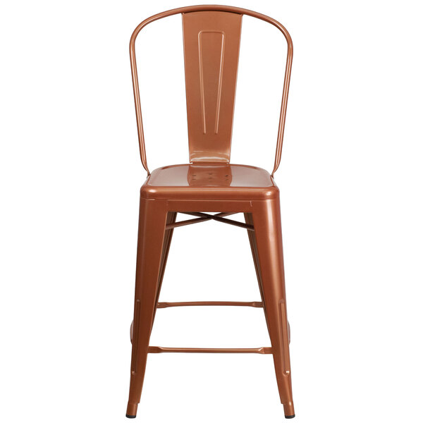 A brown metal counter height stool with a vertical slat back and a drain hole seat.