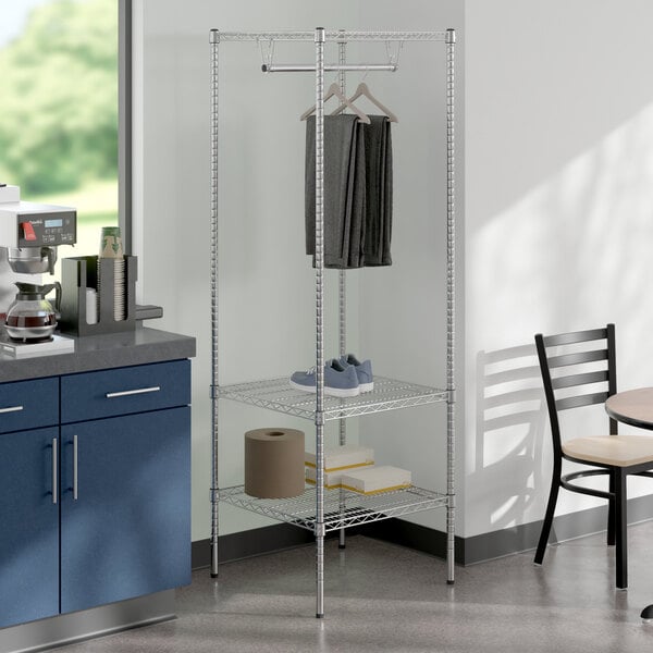 A chrome Regency garment rack with clothes on it.