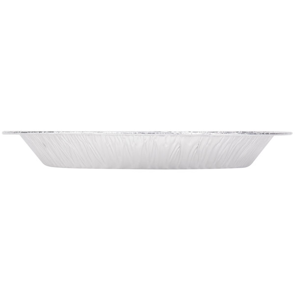 A white sheet with a round silver tray with a silver rim.