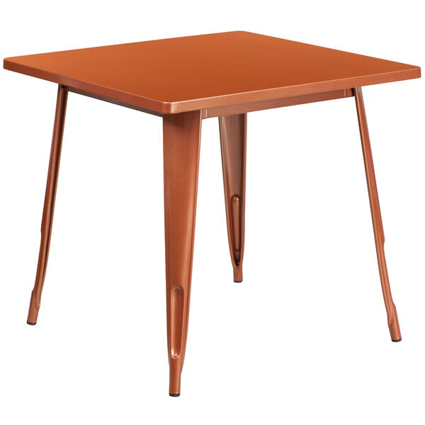 A Flash Furniture copper metal square cafe table with metal legs.