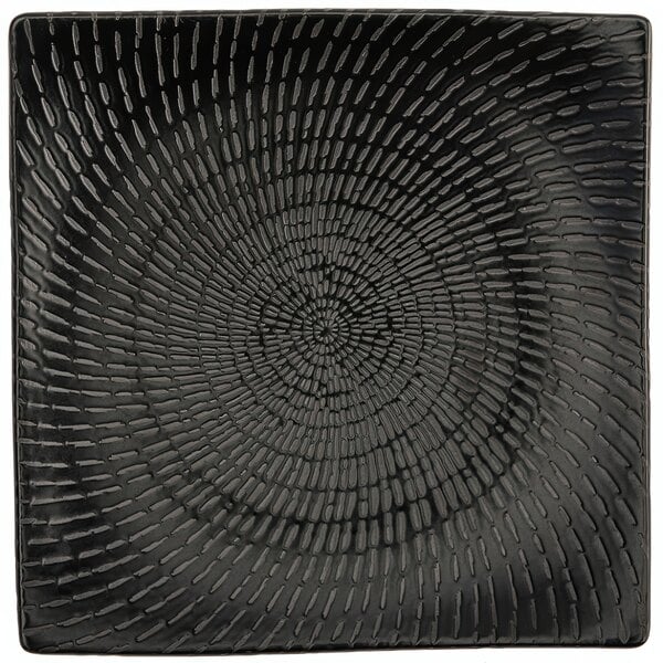 A black square Luzerne Urban porcelain plate with a spiral pattern.