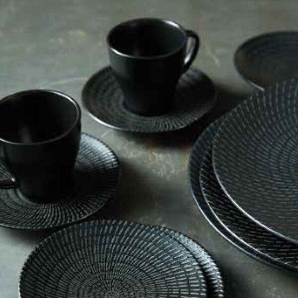 A close-up of a stack of black Oneida Urban porcelain bowls.