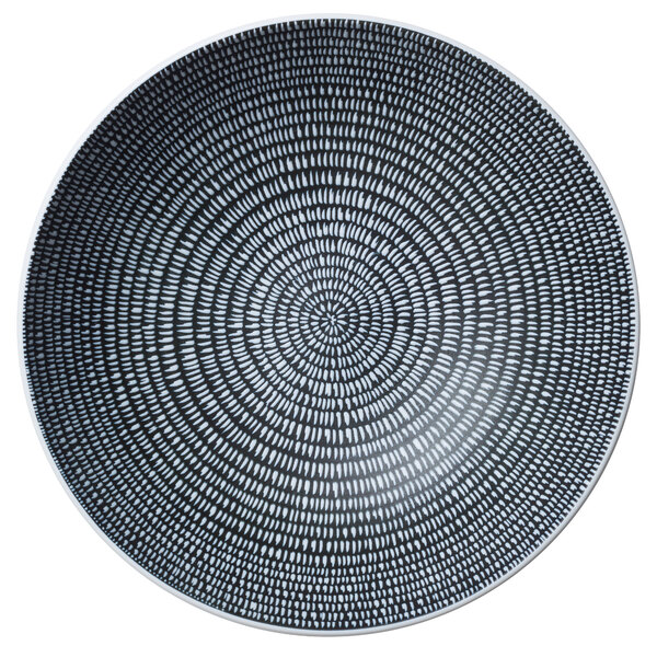 A circular black and white porcelain bowl with a spiral design.