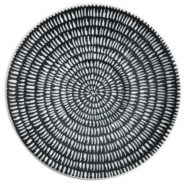 A white porcelain saucer with a black spiral design.