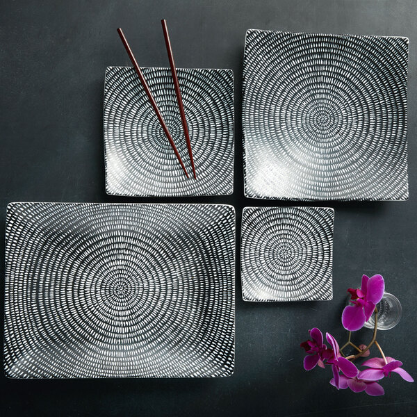 A group of Oneida Urban Storm porcelain square plates with chopsticks.