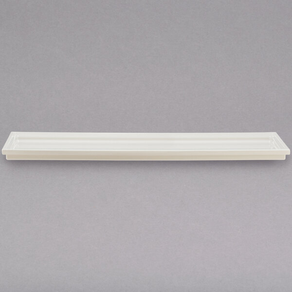 A white rectangular Bon Chef Smart Tile with a long handle.