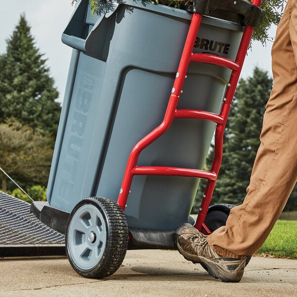 Person wearing steel toe boots using a hand truck