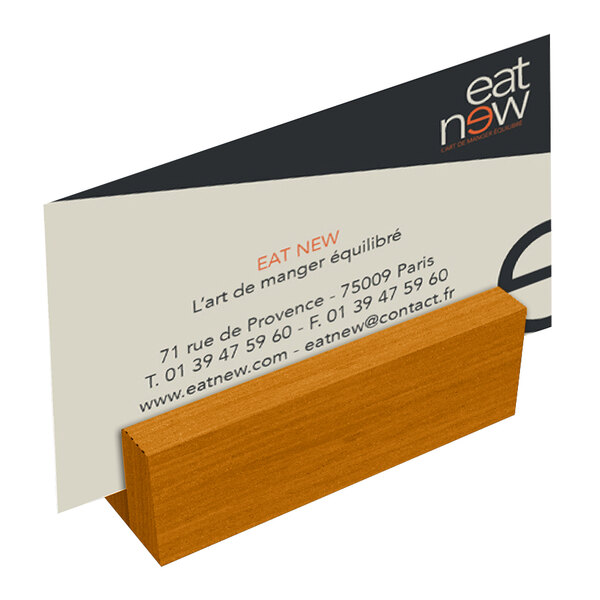A Menu Solutions Country Oak wood table card holder on a table.