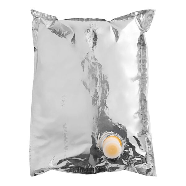 A silver Gehl's bag of Sharp Cheddar Cheese Sauce with a cap.