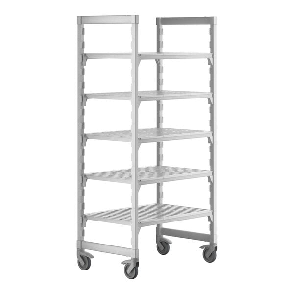 A white plastic Cambro Camshelving Premium mobile shelving unit with four shelves on wheels.