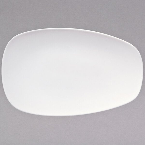 A warm white porcelain coupe platter with a small oval shape on it.