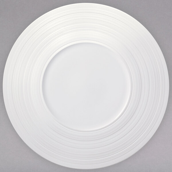 A Oneida warm white porcelain coupe plate with a wide rim and a circular pattern.