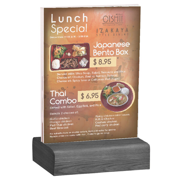 A Menu Solutions clear acrylic table tent on a wooden stand.