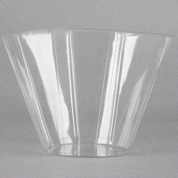 A clear plastic liner with a curved edge for a metal basket.