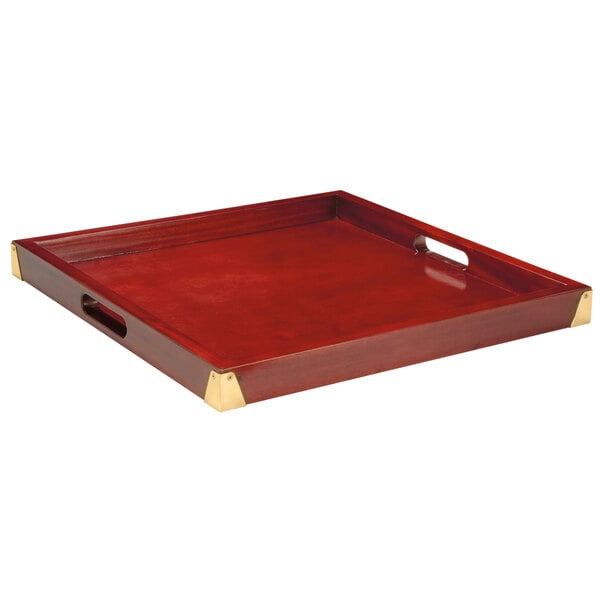 A mahogany room service tray with gold trim.