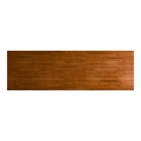 A rectangular solid wood live edge table top with a rustic walnut finish.