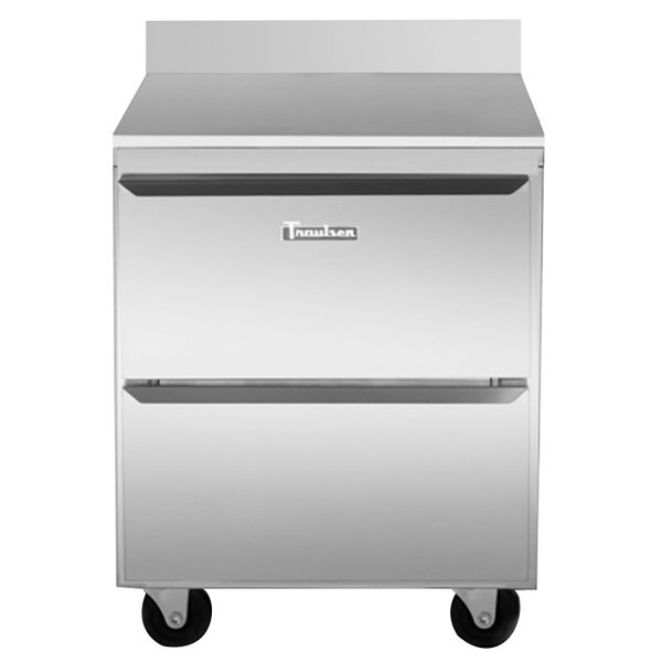 A silver Traulsen worktop refrigerator with two drawers on wheels.