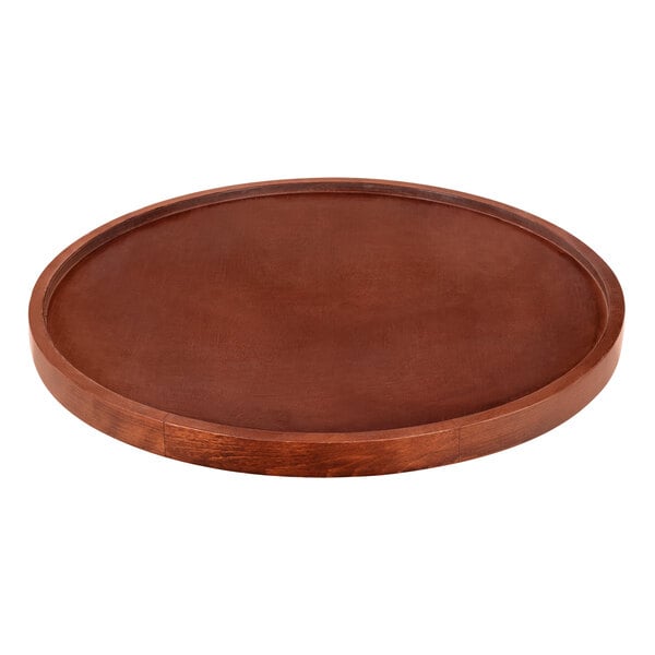 A Lancaster Table & Seating round wooden table top with a mahogany finish.