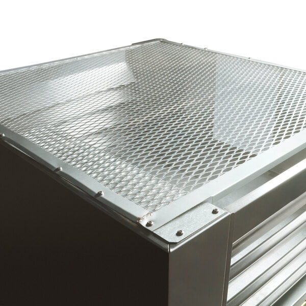 A Traulsen single section correctional pass-through refrigerator with a metal box and a mesh top.