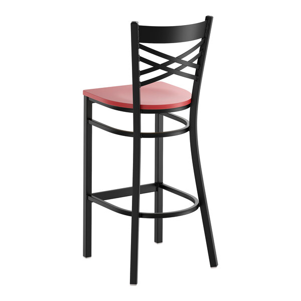 A black metal bar stool with a cross back design and a mahogany wood seat.