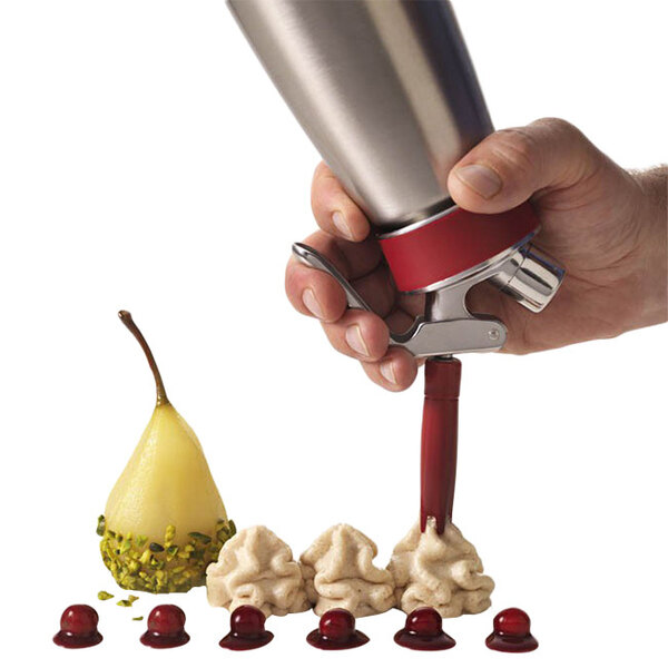 A hand holding a metal iSi cap.