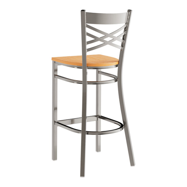 A metal bar stool with a cross back design and a natural wood seat.