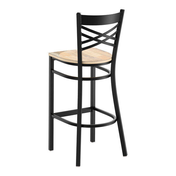 A black metal bar stool with a cross back design and a light wood seat.