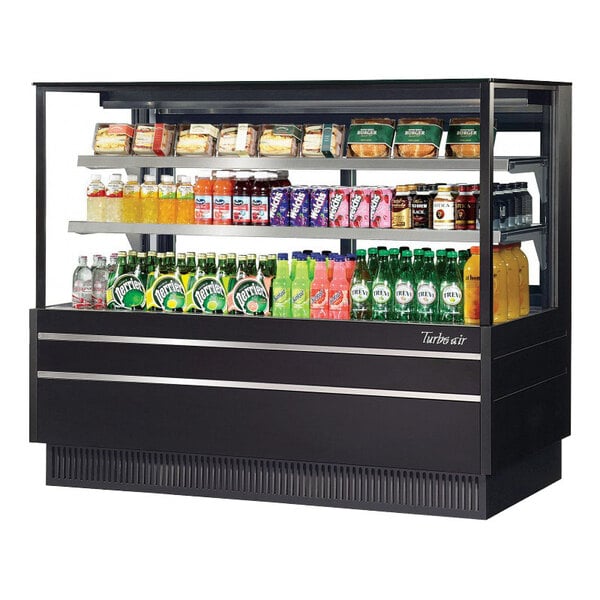 A white refrigerated bakery display case with drinks and snacks.