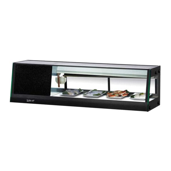 A Turbo Air refrigerated sushi case with a glass cover over sushi on a counter.