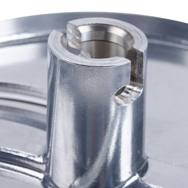 A Robot Coupe stainless steel bowl with a metal lid.