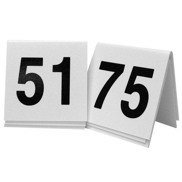 Two white Cal-Mil table tents with black numbers reading 51.