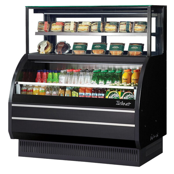 A white Turbo Air refrigerated display case with food and drinks on shelves.