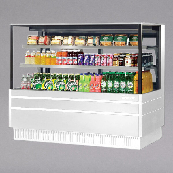 A white Turbo Air refrigerated bakery display case with drinks and snacks.