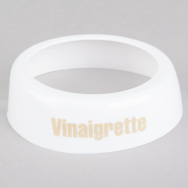 A white plastic Tablecraft salad dressing dispenser collar with beige "Vinaigrette" lettering.