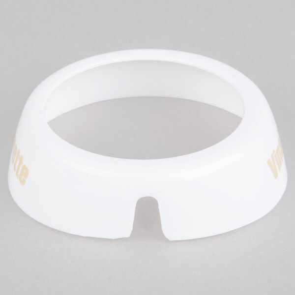 A white plastic Tablecraft salad dressing dispenser collar with beige lettering.