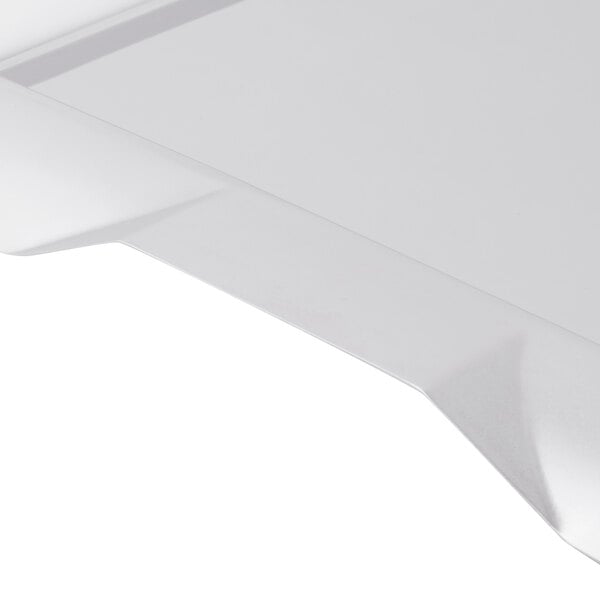 A close-up of a stainless steel square serving tray with handles.