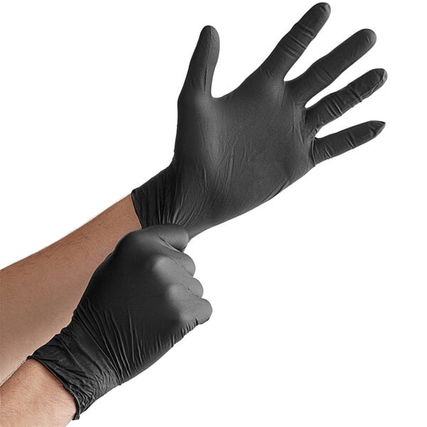 A person wearing black Lavex Pro nitrile gloves.