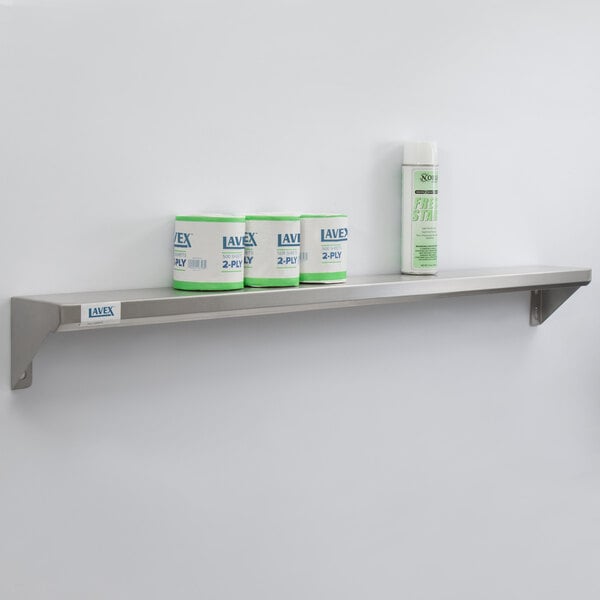 A Lavex stainless steel wall mount shelf with containers on it.