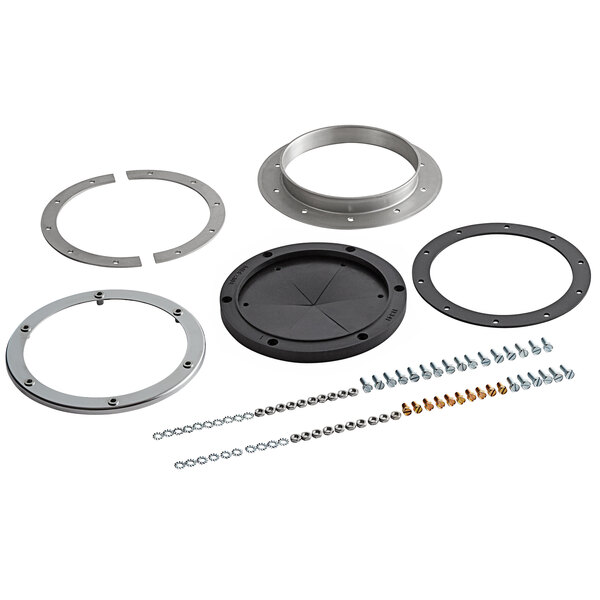 An InSinkErator disposer adapter for Salvajor cones on a table in a professional kitchen.