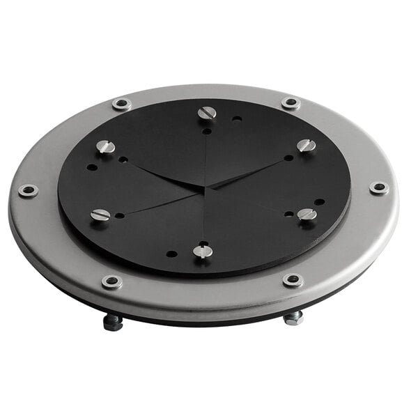 A black and silver circular plate with screws and a black circle.