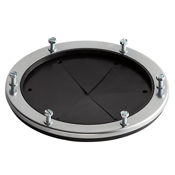A black circular metal plate with a silver rim and four screws.