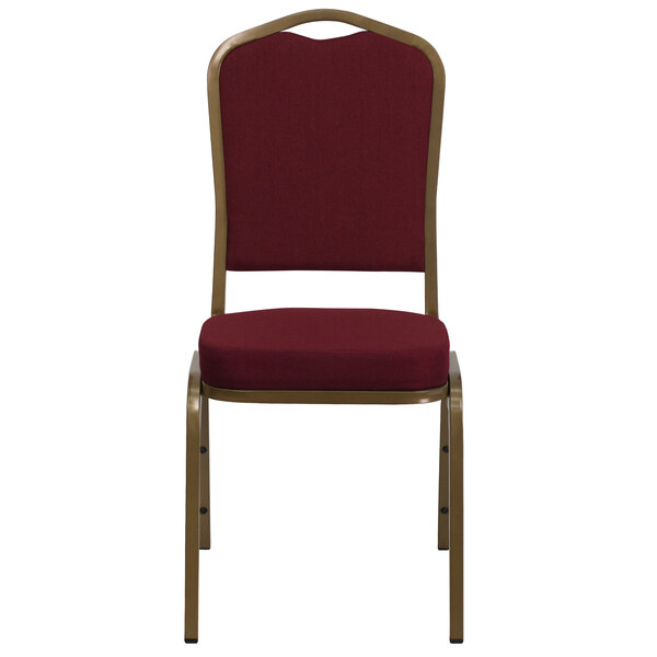 A burgundy banquet chair with gold frame.