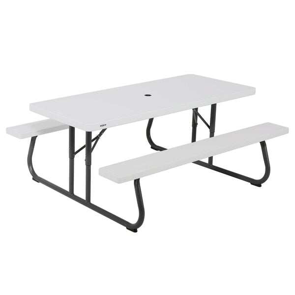 A white picnic table with attached benches.