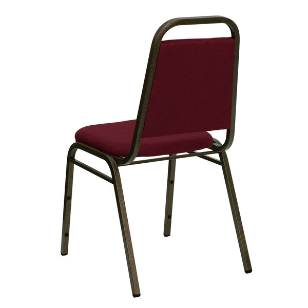 A Flash Furniture burgundy trapezoidal back banquet chair with metal legs.