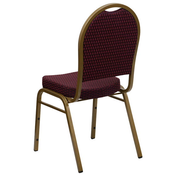 A Flash Furniture banquet chair with a gold metal frame and burgundy pattern fabric.