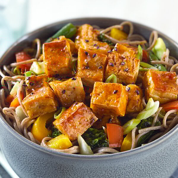 A bowl of noodles and Franklin Farms firm tofu with vegetables.
