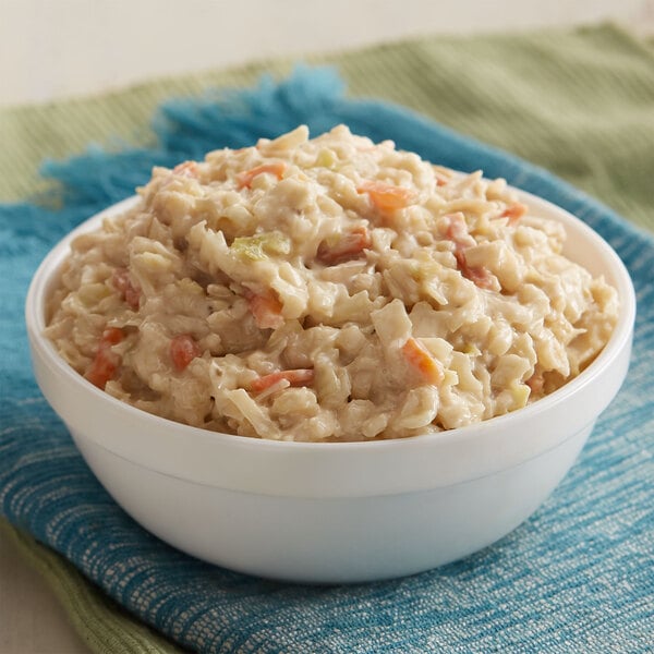 A bowl of Spring Glen Fresh Foods Creamy Coleslaw on a white napkin.