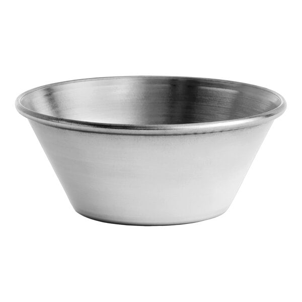A small, smooth, round stainless steel sauce cup.